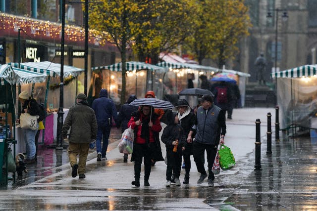 <p>People walk through Worcester city centre during rain showers as Storm Fergus and Elin sweep across Britain</p>